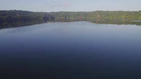 pristine rainforest surrounding freshwater crater lake water