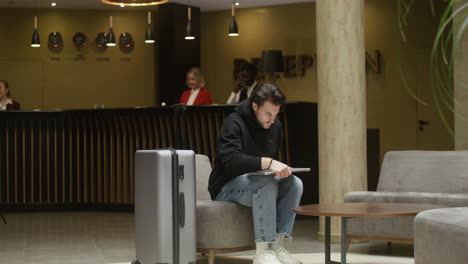 guest working on their laptop in the hotel hall