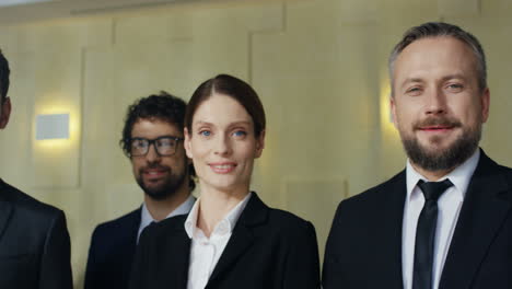 close-up view of multiethnic group of business people wearing formal clothes and smiling at a big meeting