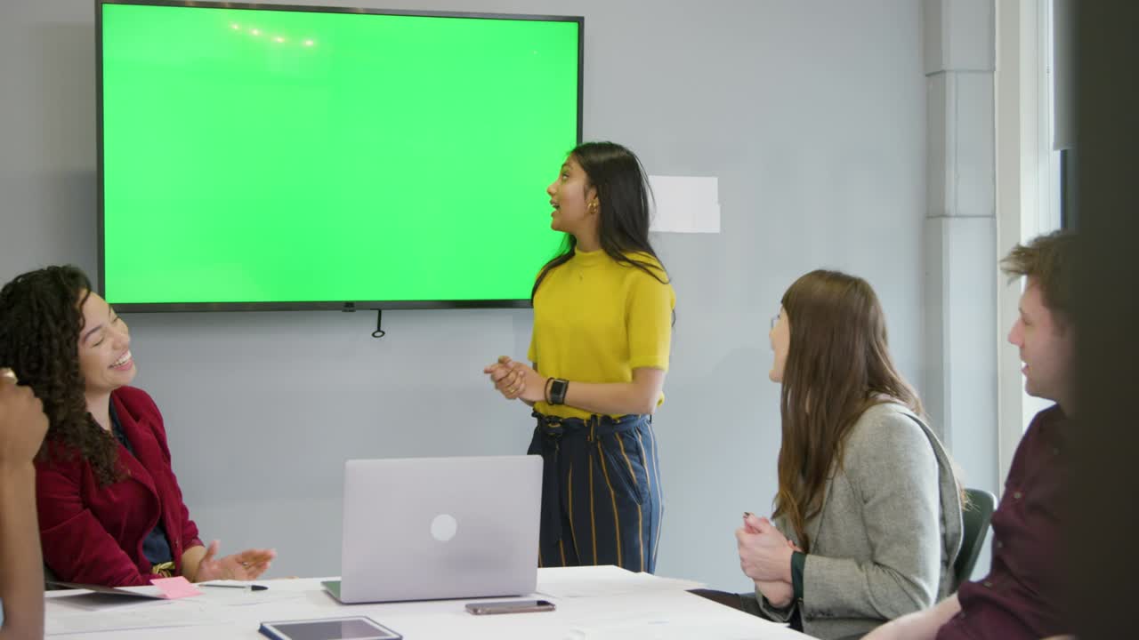 colegas en la sala de reuniones sonríen y comparten una risa