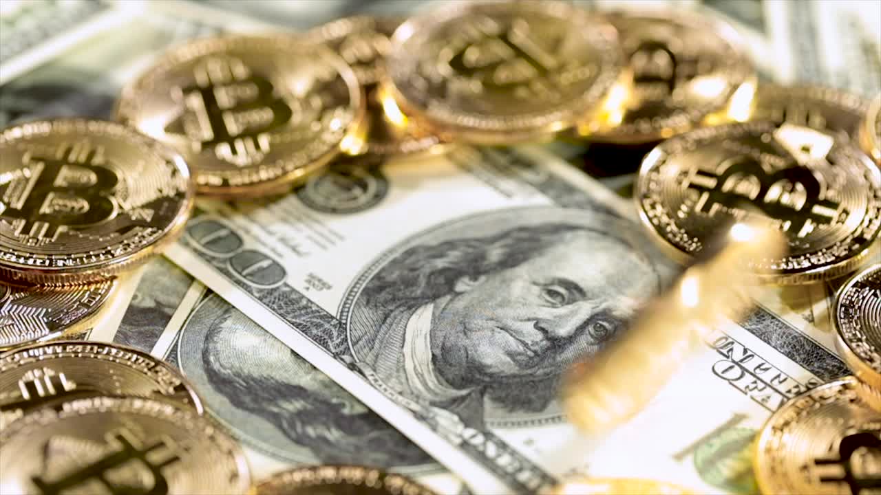 Gold Bit Coin BTC coins and dollar bills.