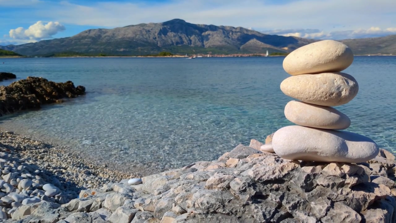 Pile of stones by the sea, calm water and peaceful landscape, peace and harmony