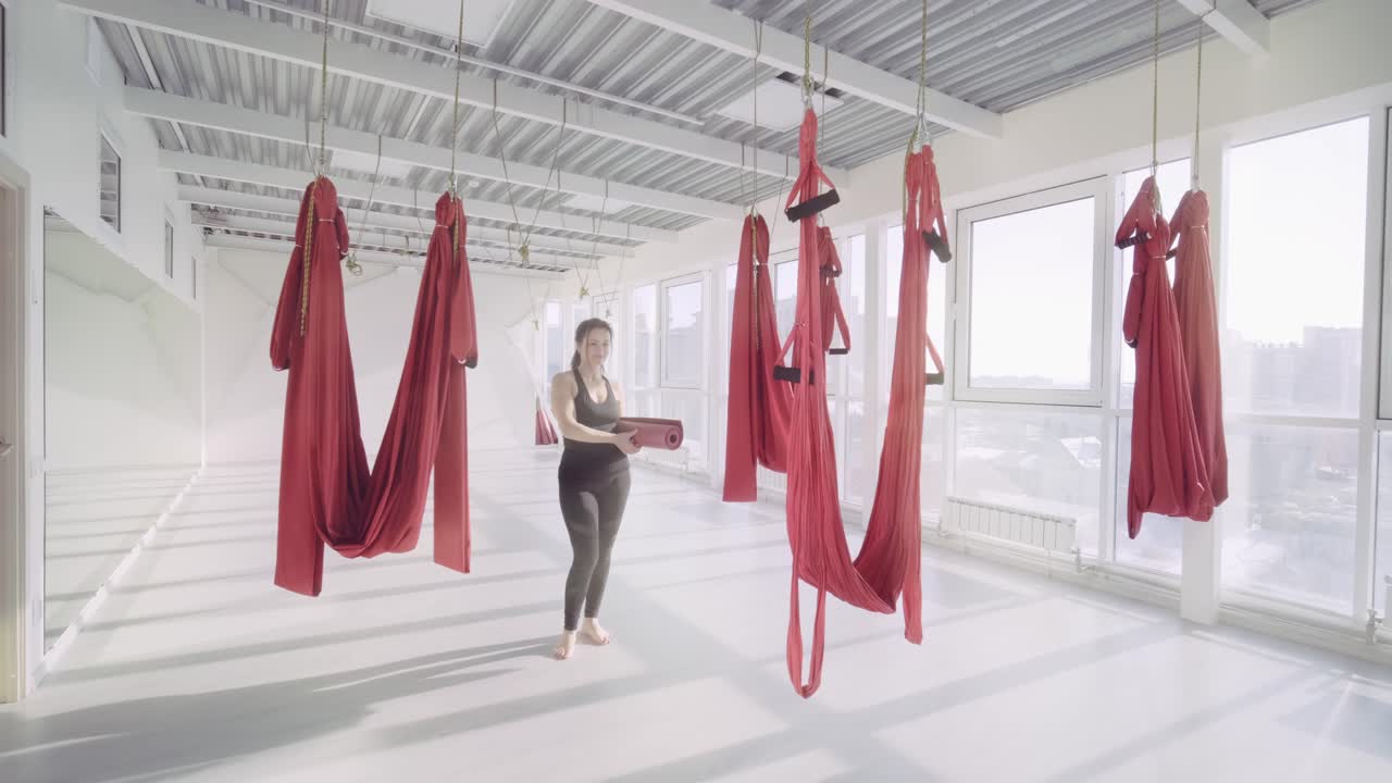 Woman Practicing Anti-Gravity Yoga in a Studio