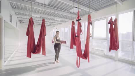 woman practicing anti-gravity yoga in a studio