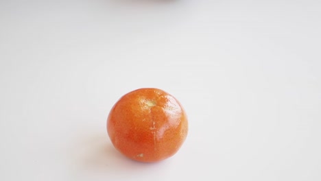 a single orange fruit on a white background