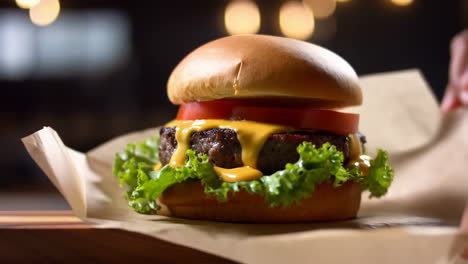 a close-up of a delicious cheeseburger with melted cheese and fresh vegetables