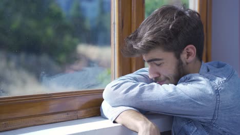 un hombre llorando solo en casa.