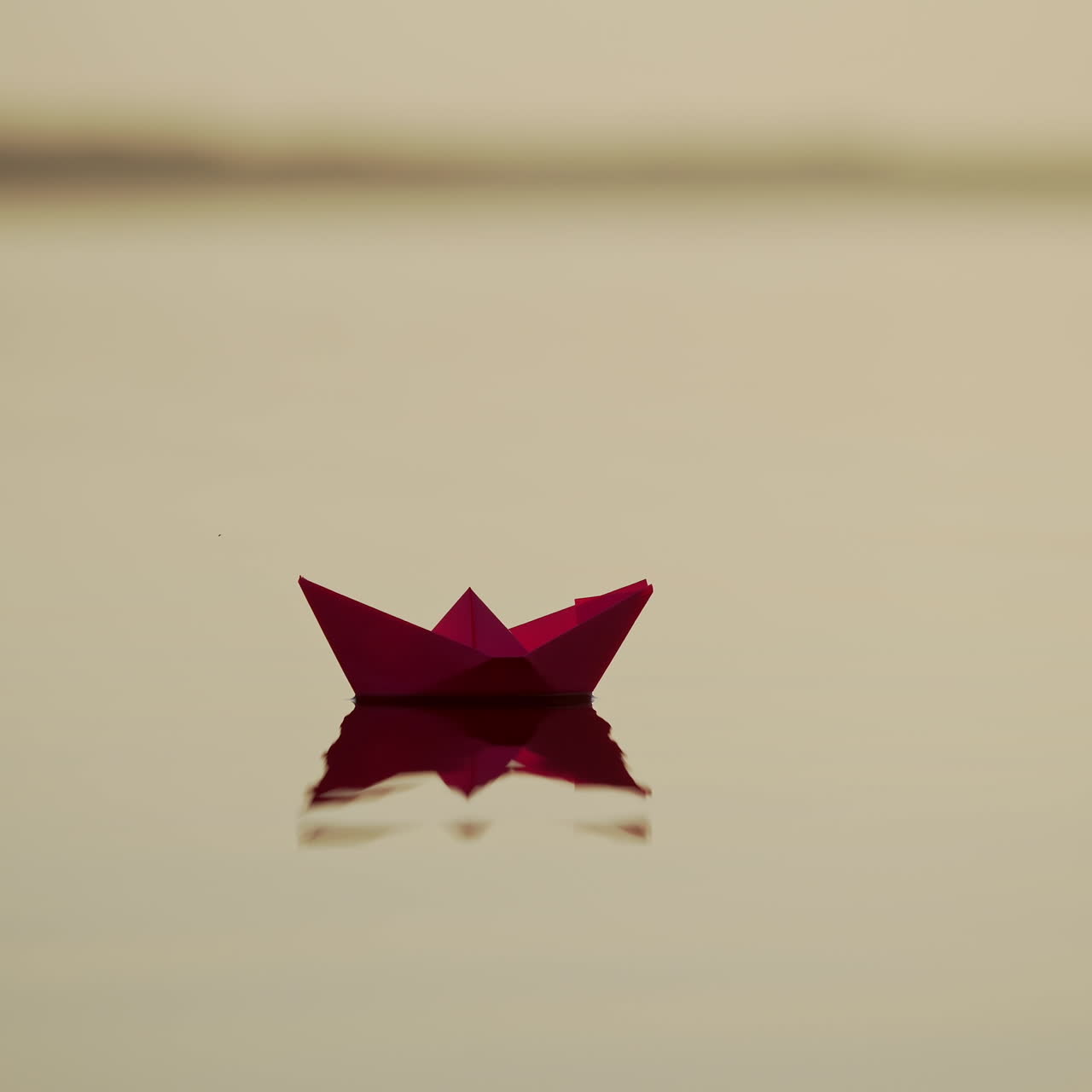 Red Paper Ship in the river. Origami Paper Boat is Sailing in the lake. Beautiful Waves Ripple Background. Unusual Travel Concept. Filtered video.