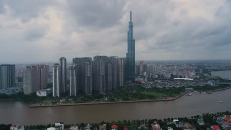 Vista-Aérea-Del-Parque-Central-Y-Rascacielos-Emblemáticos-En-El-Río-Saigon-En-La-Ciudad-De-Ho-Chi-Minh,-Vietnam-En-Un-Clima-Nublado-Y-Lluvioso