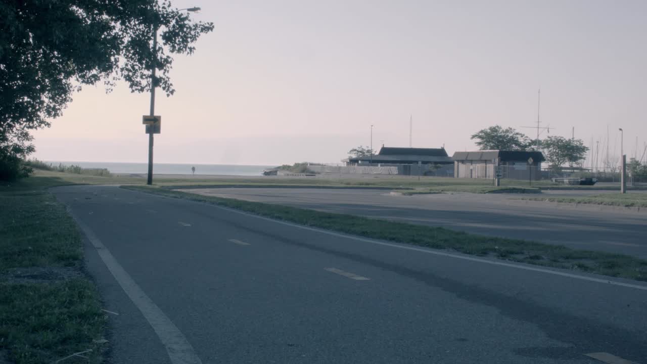 A static shot of an eerily quiet harbor port on an early Sunday morning in South Eastern Wisconsin. The loading dock is empty and there are no cars to speak of, just the wind.