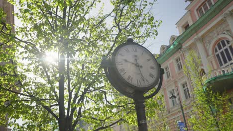 round street clock with sun at vilnius gedimino prospektas handheld