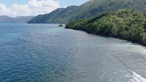 Aerial-forward-along-coastline-of-the-Dominican-Republic-on-a-sunny-summer-day