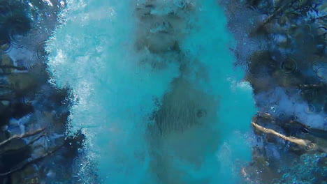 a man swims in the pool swims over the camera underwater video slow motion