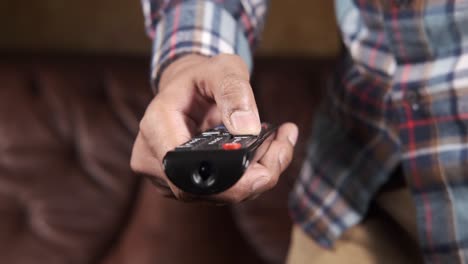 person holding tv remote