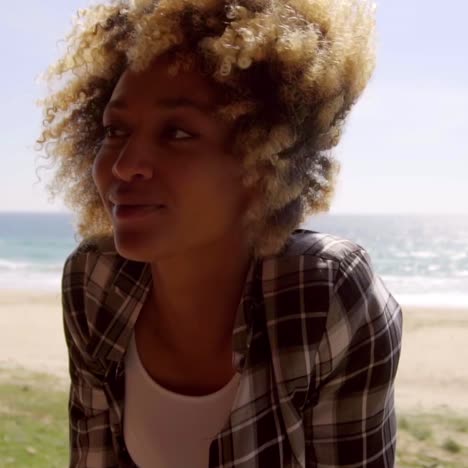 young woman sitting on a beachfront balcony