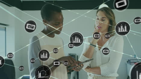 animation of icons connected with lines over diverse coworkers discussing reports on digital tablet