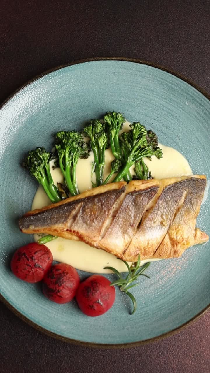 Gourmet fish dish with broccolini and tomatoes