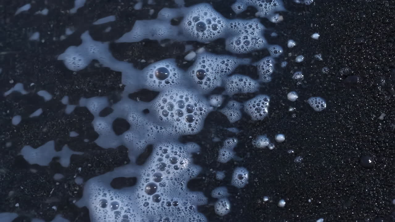 White Foam and Bubbles on a Dark Surface