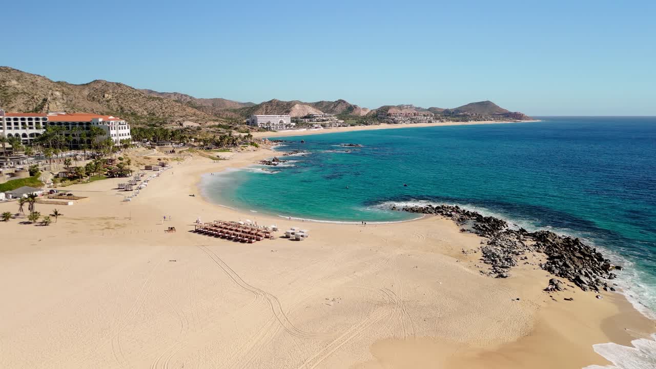 Cabo San Lucas Mexico near San José del Cabo drone view flying around a cove with rocks and small waves.