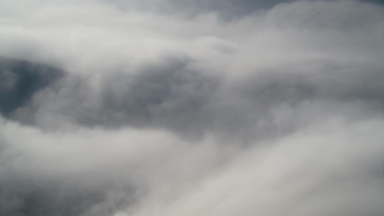 Dense Clouds Moving Over Mountain Landscape