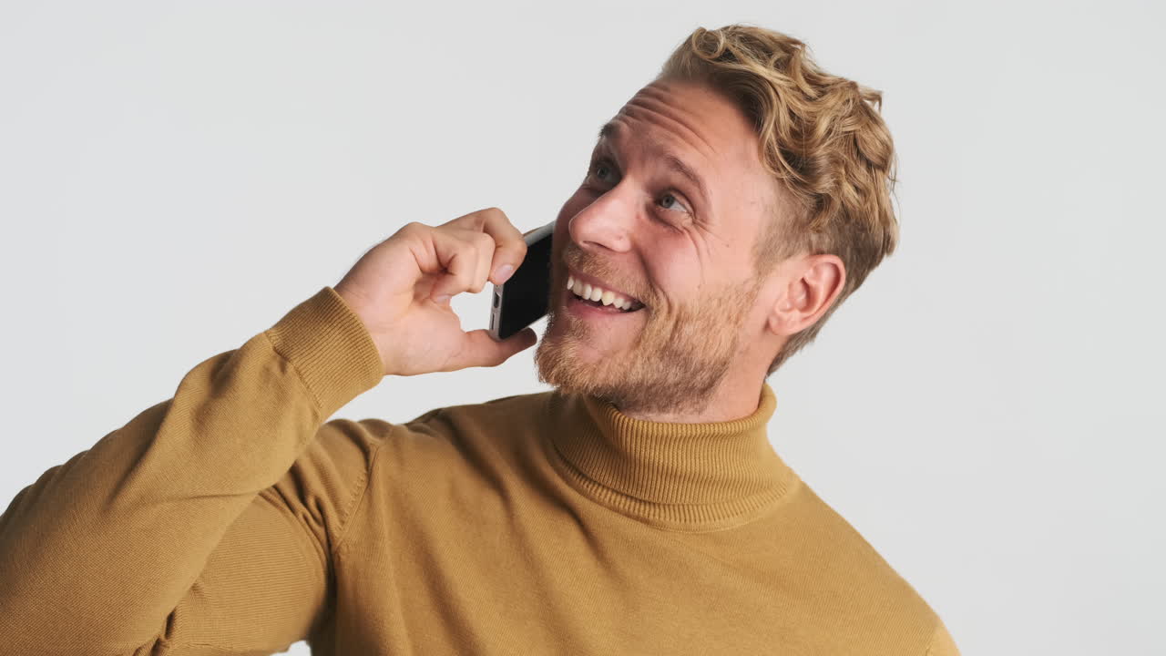 Happy man laughing and talking on phone