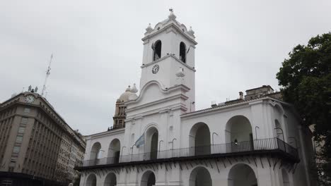 cabildo of buenos aires colonial white building, establishing skyline with city