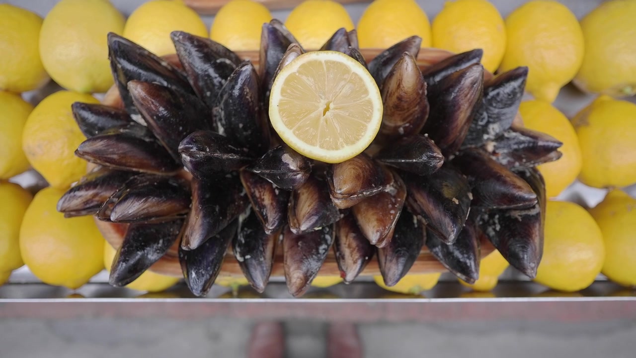 Fresh Mussels Served with Lemon on a Wooden Platter