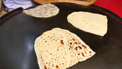 cooking turkish flatbread on a griddle