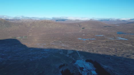 Glencoe-Valley-with-scattered-lochs,-early-morning-light,-aerial-view