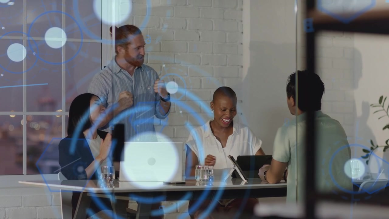 Business team exchanging high-five while celebrating win and reviewing tablet with blue HUD overlay