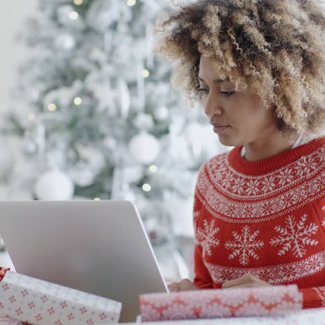 Trendy-young-woman-working-on-a-laptop