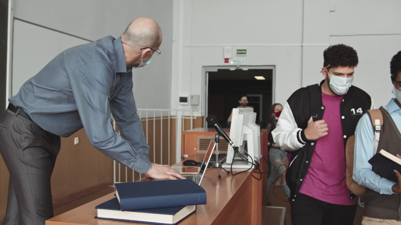 University Professor Tracking Students Attendance in Class