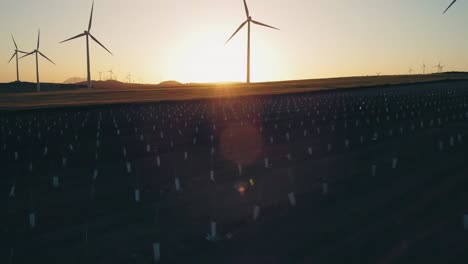 array of wind turbines on countryside field at