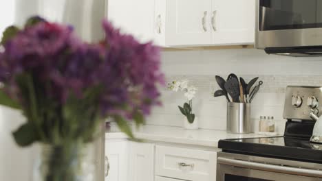 Rack-focus-shot-of-modern-white-newly-upgraded-kitchen-cabinets-and-fixtures