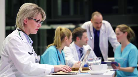 doctor using laptop in conference room