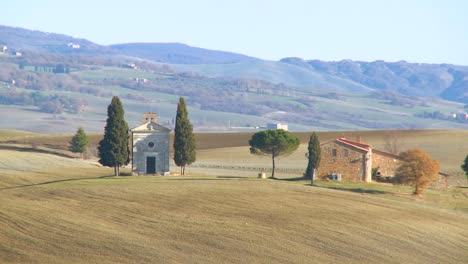 a beautiful farmhouse and church in tuscany italy