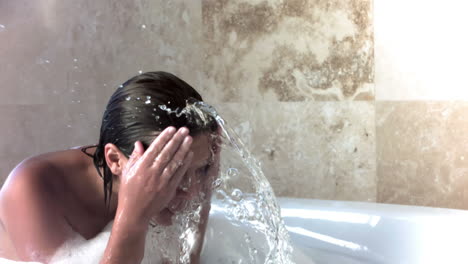 brunette woman in slow motion taking a bubble bath