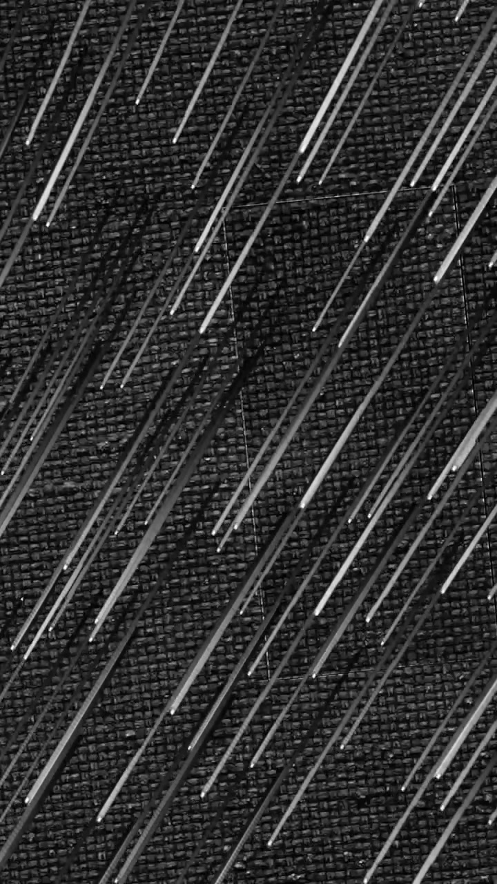 Animation of white lines falling on black background