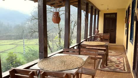 local house cottage hut wooden cabin lodge in the forest in orange yellow autumn fall scenic winter view of balcony terrace rice field paddy sit on wood dining table traditional food art carpet iran