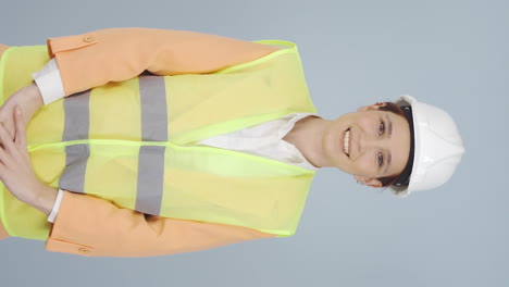 Vertical-video-of-The-engineer-wearing-a-hard-hat-and-smiling.