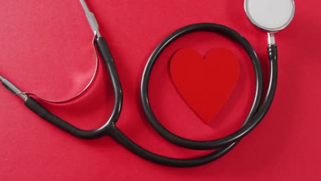 video of close up of heart and stethoscope on red background