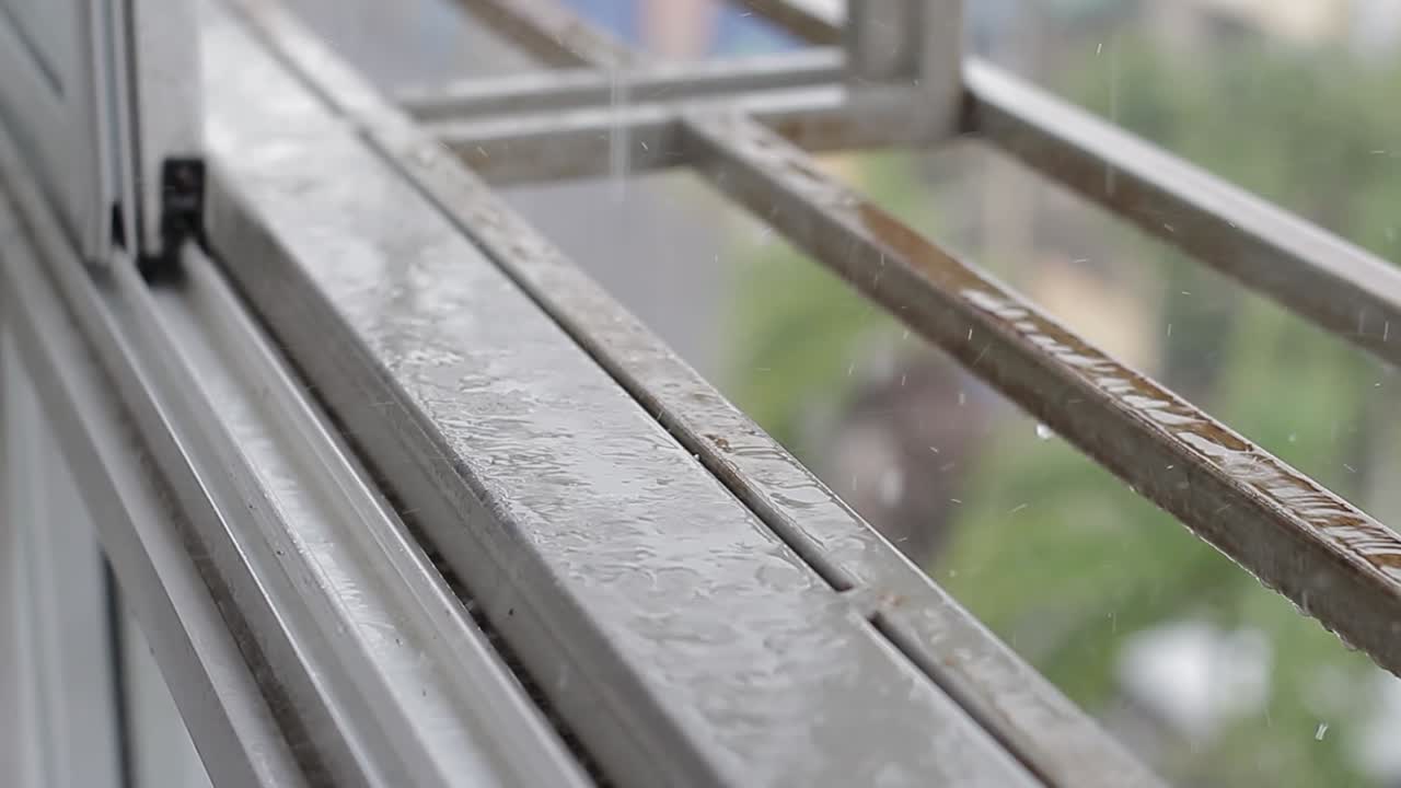 Rainy weather through window drops nearby