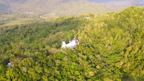 orbit drone shot of white church building in the rhema hill