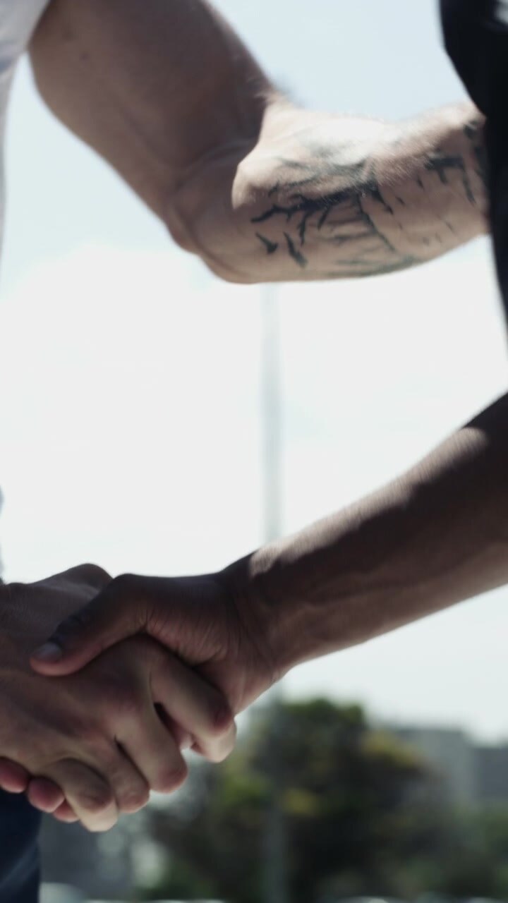 Athletes Shaking Hands and Greeting Each Other on Sports Field