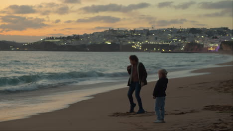 Siblings-on-beach-boy-dancing