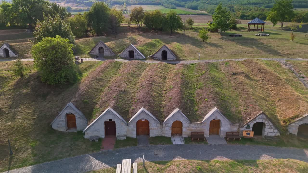 Aerial panning view from the entrances of the Kőporosi Pincesor cellars with the local vineyards in the background in Hercegkút, Hungary