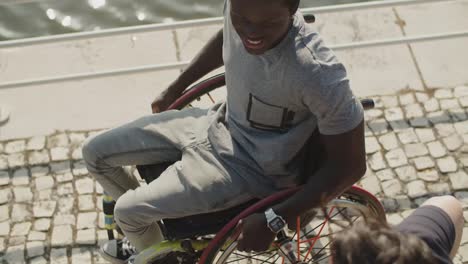 above view of happy african american man using wheelchair