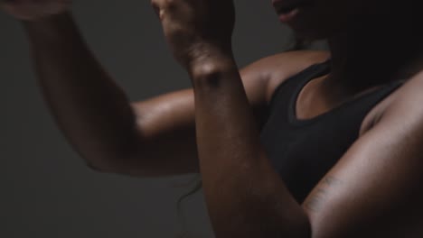 studio portrait of young woman wearing fitness clothing training for boxing in gym 5