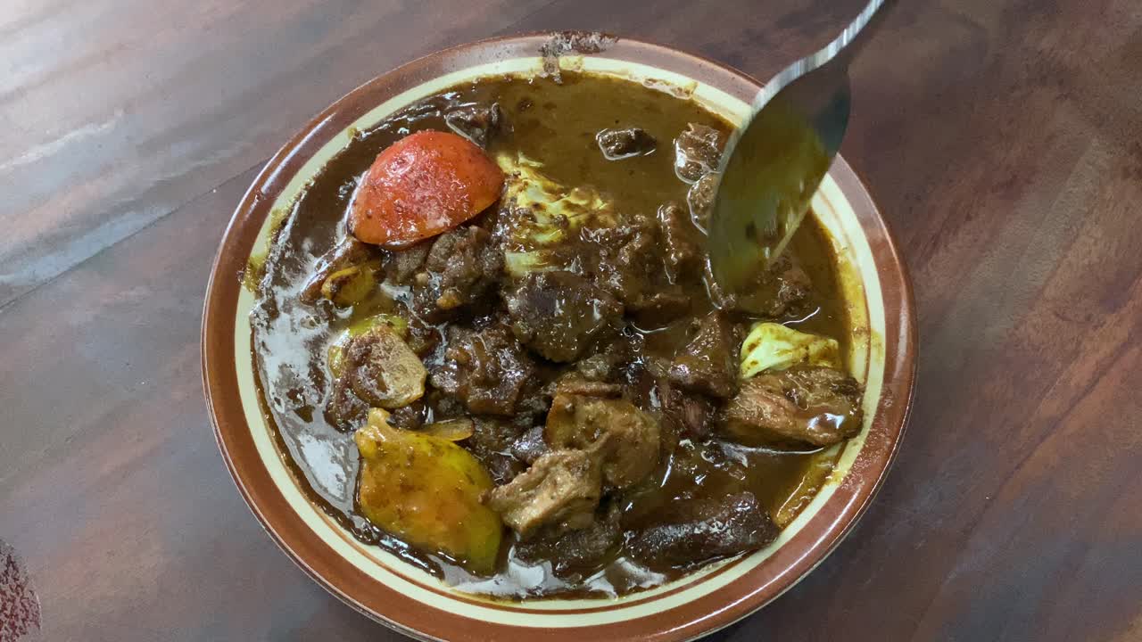 Tongseng delicious food served on a plate. Goat meat stew cooked with sweet soy sauce, coconut milk, sliced   cabbage, and tomatoes. Commonly found in Central Java, from Surakarta to Yogyakarta.