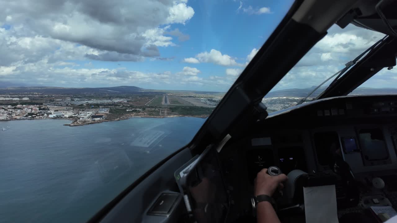 An immersive Pilot’s eye view in the finnal approach to Palma de Mallorca’s airport, overflying over the mediterranean Sea, with he runway ahead under a partially clouded sky